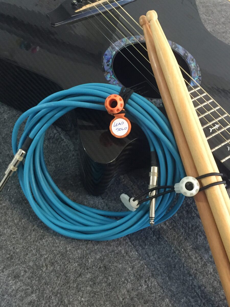 Guitar cable bundled and drumsticks wrapped